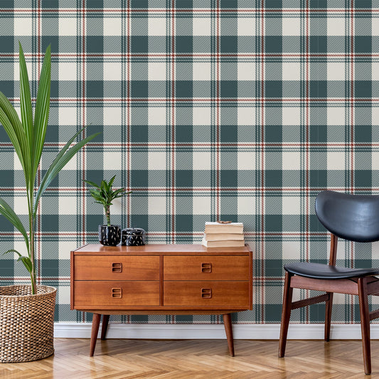 A living room with a black leather chair and a low amber wood side table, with a tall leafy plant to the side of it. Showing 'Brielle' which is a neutral blue wallpaper featuring a buffalo check gingham plaid pattern with soft blue, cream and grey squares in a fabric-inspired repeating design.