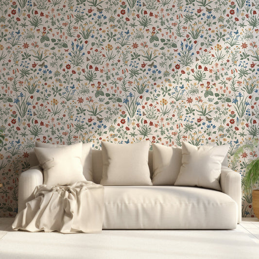A living room with a cream coloured sofa featuring the Mallory wallpaper which is pastel botanical colourful flowers, leafy plants and butterflies on a light grey background in a delicate repeating pattern.