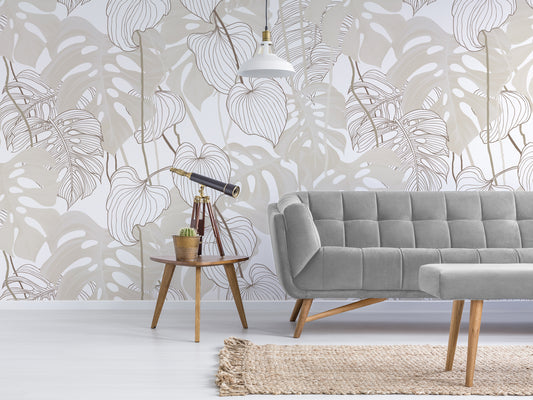 Daphne Neutral Monstera Leaf Wallpaper with Grey Sofa and Accent Telescope