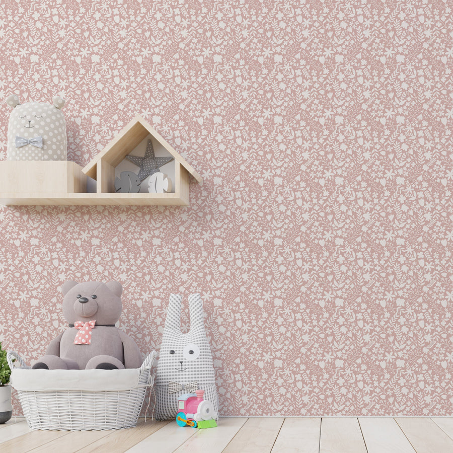 A children's nursery with shelving and plush toys on the floor featuring Deliah which is a ditsy floral wallpaper featuring small wild meadow flowers and delicate green foliage scattered across a soft neutral background in a charming repeating pattern.