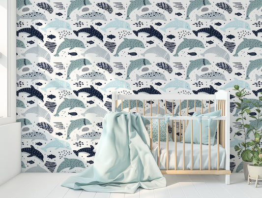 Delphine Wallpaper In Nursery Room With Baby Blue Cot & Large Blanket & Green Leafy Plant
