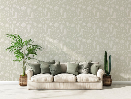 Dolly Western Cowbiy Boot And Snakes Wallpaper In Living Room With White Sofa With Green Cushions On It And A Cactus On The Right And A Leafy Plant On The Left Of The Sofa