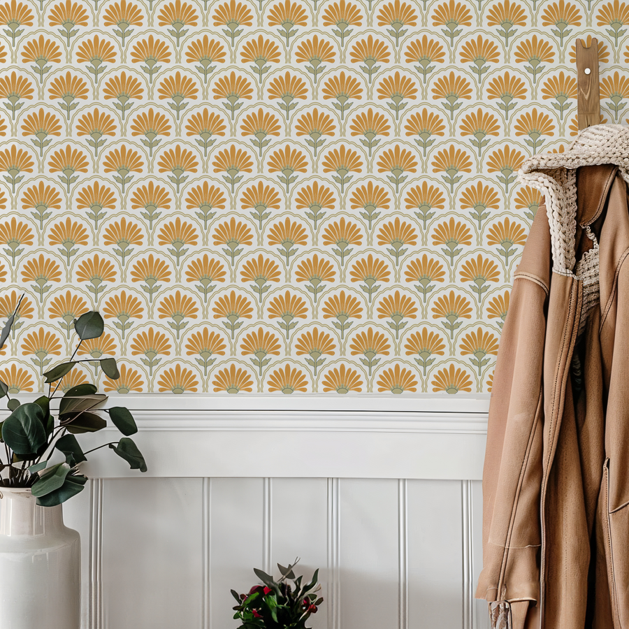 An entryway into a house with a coat hanging up showing 'Anya' which is a geometric floral wallpaper featuring stylised flowers and repeating geometric shapes in a modern abstract pattern with soft muted tones.