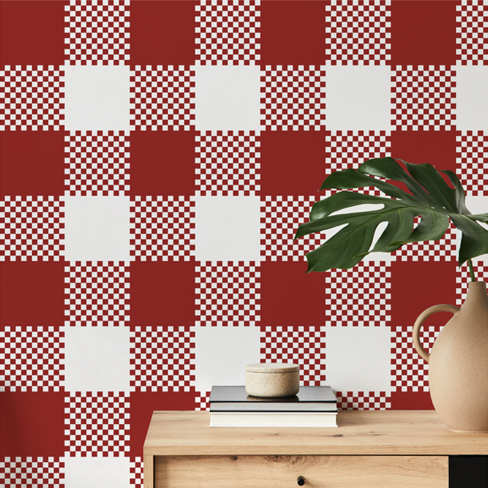 poppy pink plaid wallpaper on a hallway wall with an oak console table and monstera