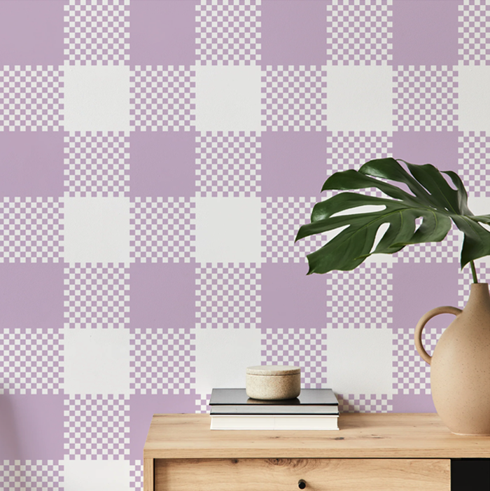 thistle pink plaid wallpaper on a hallway wall with an oak console table and monstera