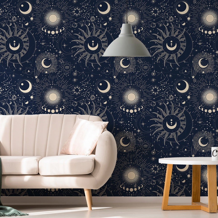 A living room with a cream sofa with a grey light above it showing 'Athena' which is a celestial wallpaper featuring moon phases, stars and constellation illustrations on a dark blue background in a repeating night sky pattern.